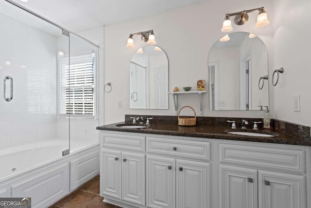 full bathroom featuring a sink, enclosed tub / shower combo, double vanity, and tile patterned flooring