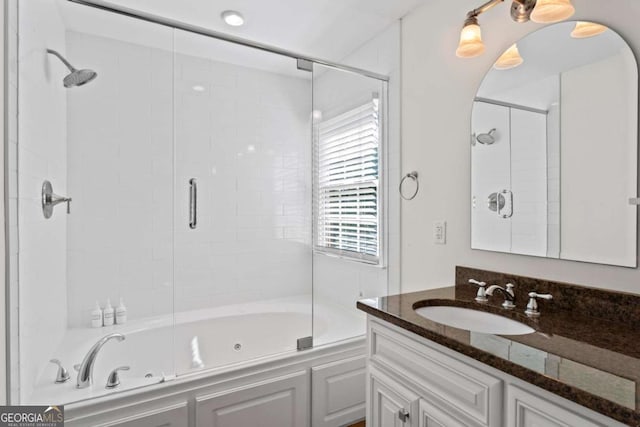 full bathroom featuring vanity and a combined bath / shower with jetted tub