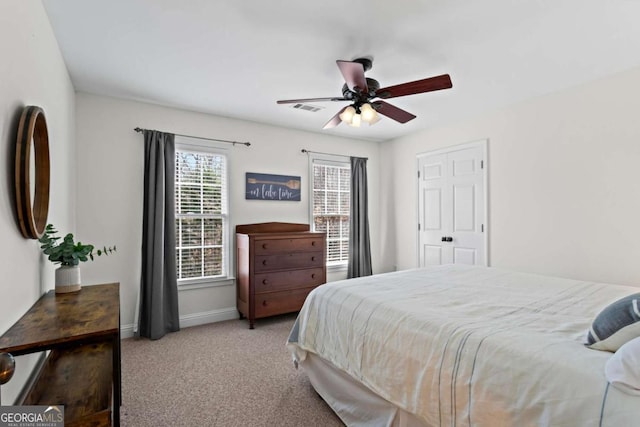 bedroom featuring a ceiling fan, carpet, visible vents, and baseboards