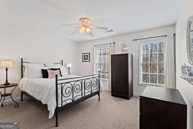 bedroom with visible vents, baseboards, carpet, and a ceiling fan