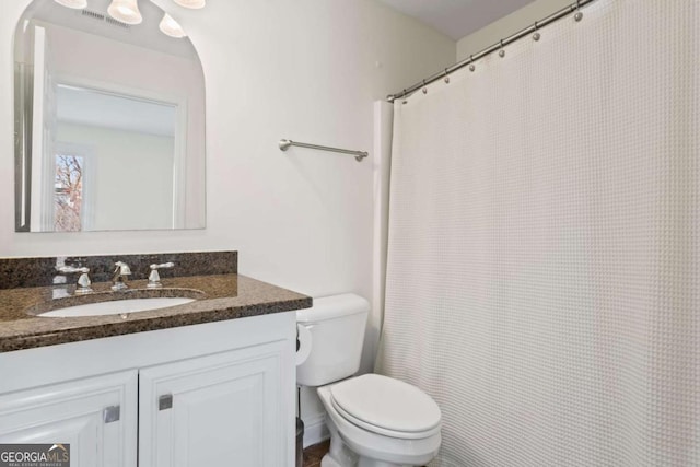 full bathroom featuring vanity, toilet, and visible vents