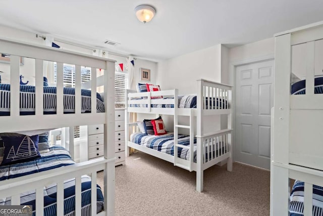 bedroom with visible vents and carpet