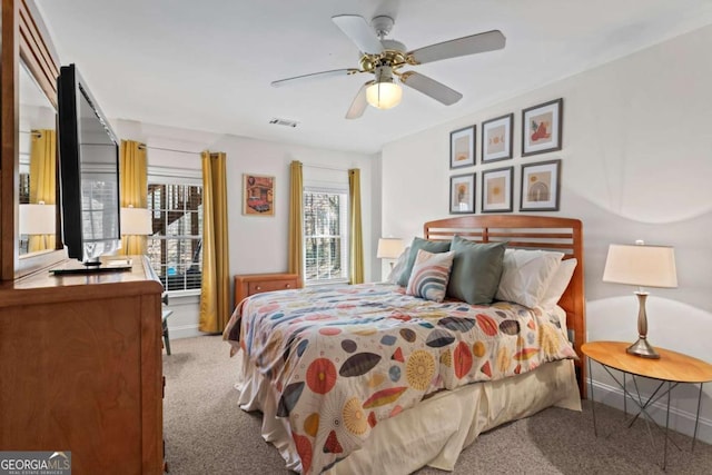 carpeted bedroom featuring visible vents