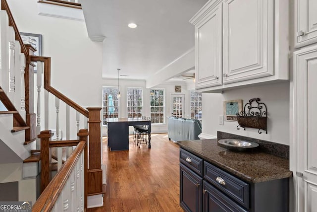 kitchen featuring recessed lighting, pendant lighting, white cabinetry, blue cabinets, and light wood-type flooring