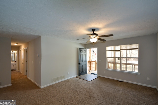 98 Brenda Cir, Rockmart, GA 30153 - unfurnished living room with carpet flooring, baseboards, visible vents, and ceiling fan
