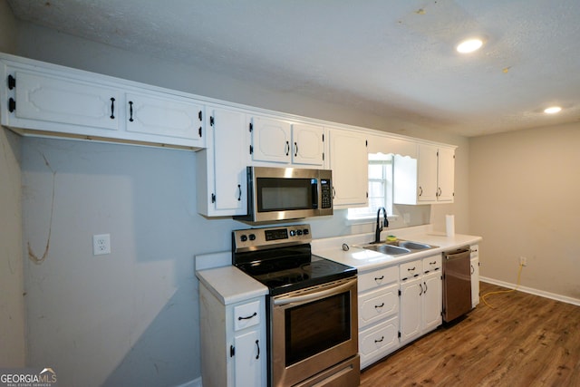 98 Brenda Cir, Rockmart, GA 30153 - kitchen with a sink, appliances with stainless steel finishes, white cabinets, and light countertops
