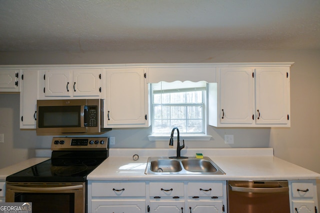 98 Brenda Cir, Rockmart, GA 30153 - kitchen featuring a sink, appliances with stainless steel finishes, light countertops, and white cabinetry
