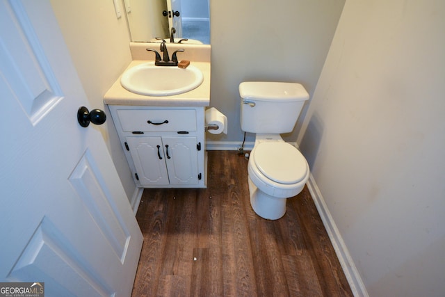 98 Brenda Cir, Rockmart, GA 30153 - half bathroom featuring baseboards, toilet, wood finished floors, and vanity