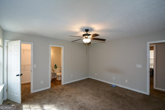 98 Brenda Cir, Rockmart, GA 30153 - unfurnished bedroom with a walk in closet, ensuite bath, a closet, carpet, and baseboards
