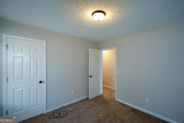 98 Brenda Cir, Rockmart, GA 30153 - unfurnished bedroom featuring carpet flooring, a textured ceiling, and baseboards