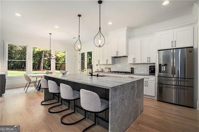 396 Academy St, Alpharetta, GA 30009 - kitchen with stainless steel refrigerator with ice dispenser, plenty of natural light, white cabinets, wood finished floors, and recessed lighting