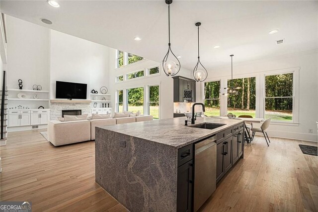 396 Academy St, Alpharetta, GA 30009 - kitchen with a sink, stainless steel dishwasher, recessed lighting, a fireplace, and light wood-type flooring