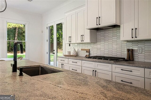 396 Academy St, Alpharetta, GA 30009 - kitchen with a sink, tasteful backsplash, light stone counters, stainless steel gas stovetop, and white cabinets