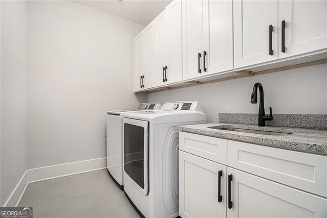 396 Academy St, Alpharetta, GA 30009 - washroom featuring washing machine and clothes dryer, cabinet space, and baseboards