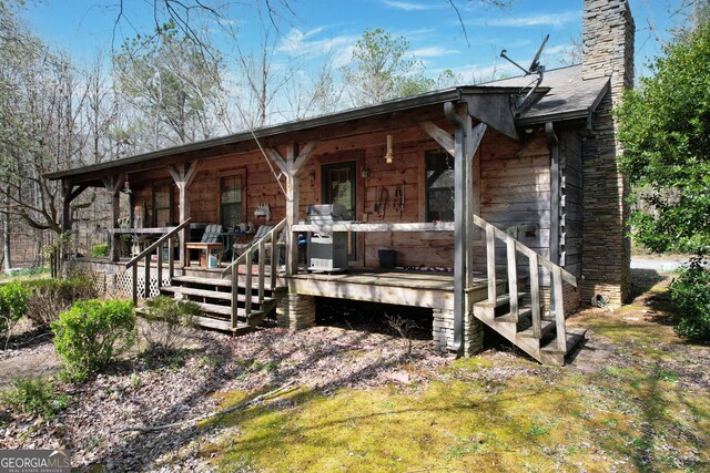 exterior space with covered porch and a chimney
