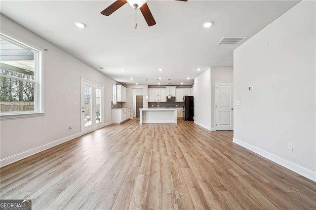 unfurnished living room featuring baseboards, visible vents, light wood-style flooring, recessed lighting, and ceiling fan