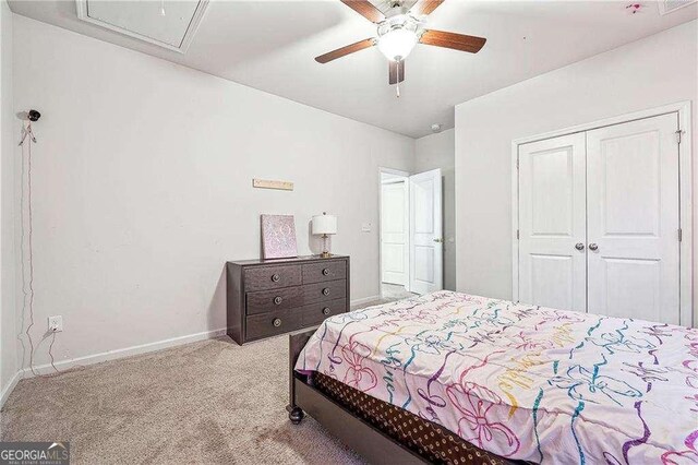 bedroom featuring baseboards, carpet floors, a closet, and ceiling fan