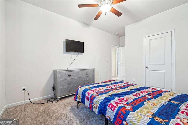 carpeted bedroom with baseboards and ceiling fan