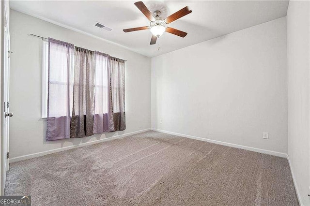 spare room featuring visible vents, ceiling fan, baseboards, and carpet