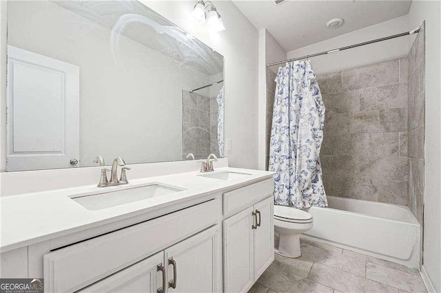 full bathroom with double vanity, toilet, shower / bathtub combination with curtain, and a sink