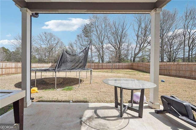 view of patio / terrace featuring a trampoline and a fenced backyard