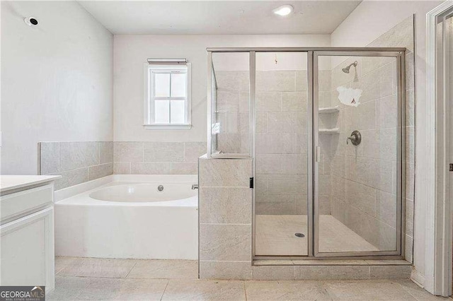 bathroom with vanity, a garden tub, tile patterned flooring, and a shower stall