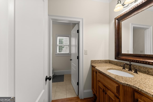 bathroom featuring baseboards, vanity, and tile patterned flooring