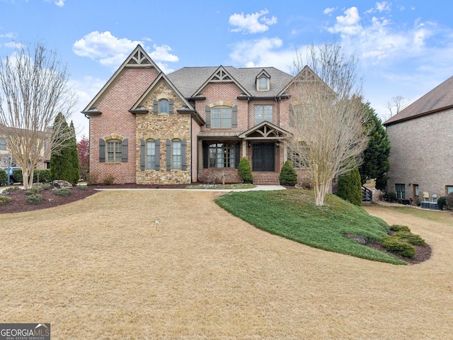 view of front of house featuring a front yard and brick siding
