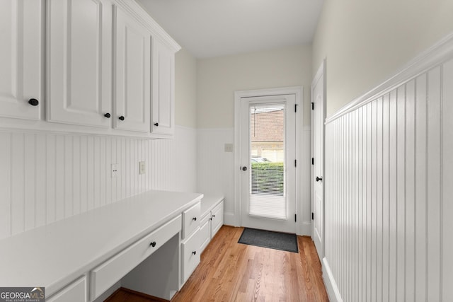 mudroom featuring a wainscoted wall and light wood-type flooring