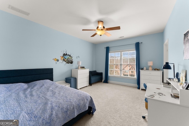 bedroom with visible vents, light colored carpet, baseboards, and ceiling fan