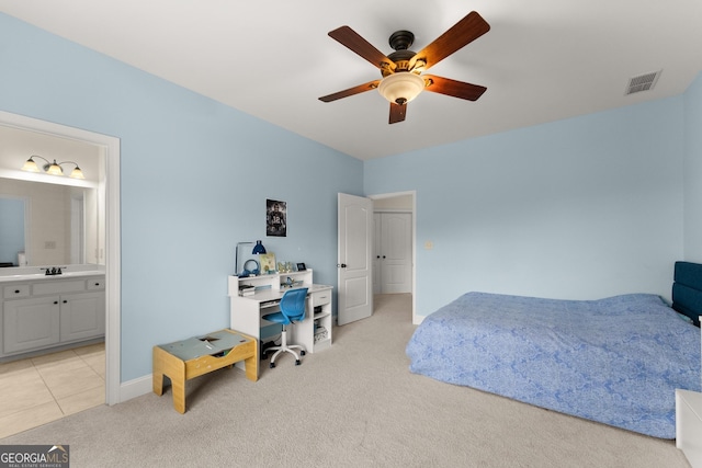bedroom featuring visible vents, connected bathroom, baseboards, ceiling fan, and light carpet