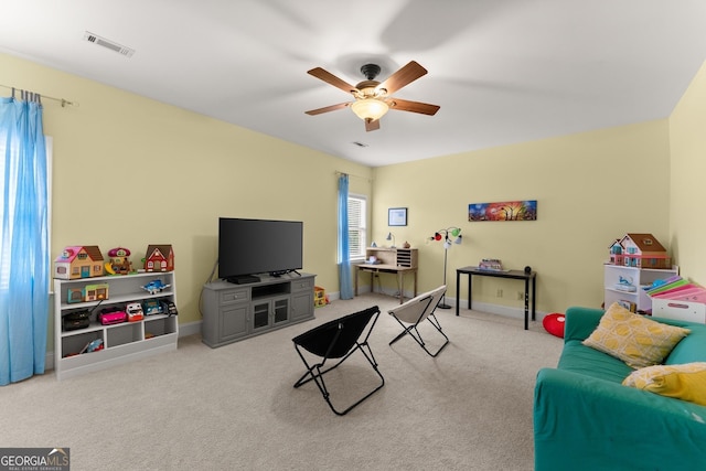 carpeted living room featuring visible vents, baseboards, and ceiling fan