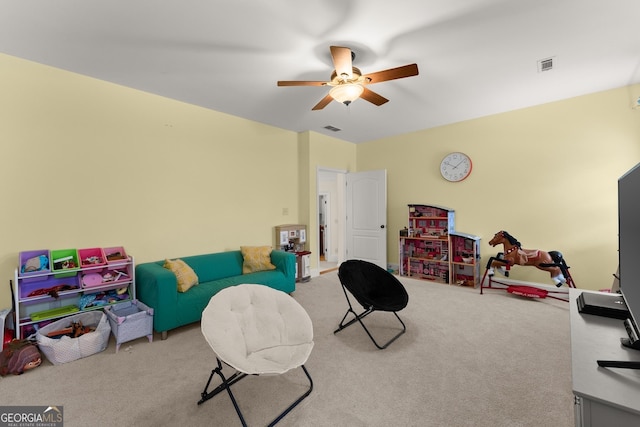 recreation room featuring visible vents, carpet floors, and a ceiling fan