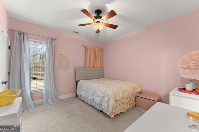 carpeted bedroom with visible vents, ceiling fan, and baseboards