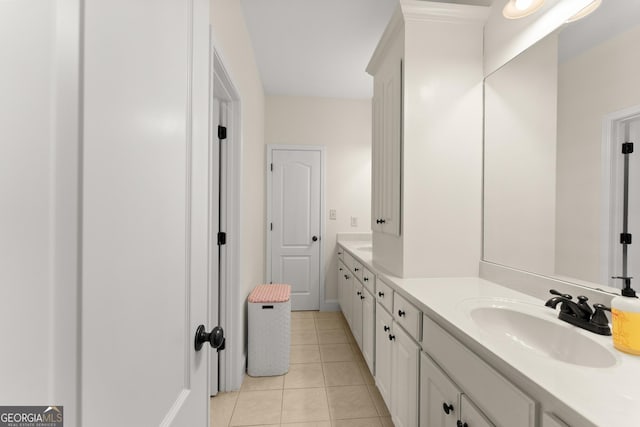 bathroom featuring double vanity, tile patterned floors, and a sink