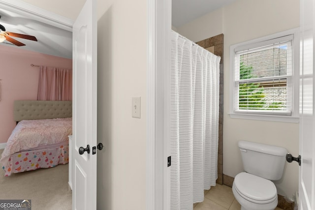 bathroom with tile patterned floors, toilet, ensuite bath, a shower with shower curtain, and ceiling fan
