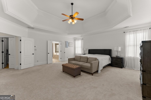 bedroom featuring visible vents, crown molding, ensuite bathroom, light carpet, and a raised ceiling