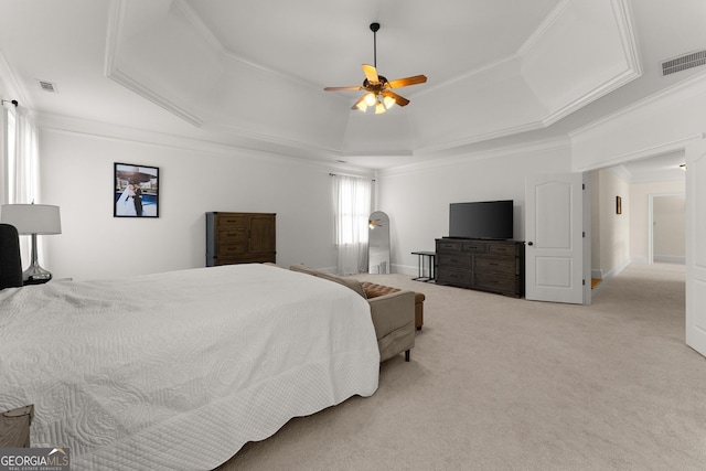 bedroom with visible vents, a raised ceiling, light carpet, and ornamental molding