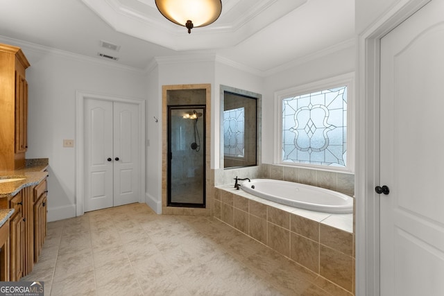 bathroom with vanity, a stall shower, crown molding, a raised ceiling, and a bath