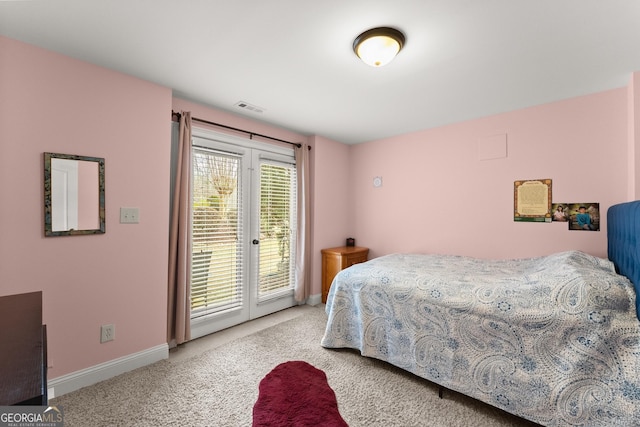 bedroom with access to outside, light colored carpet, visible vents, and baseboards