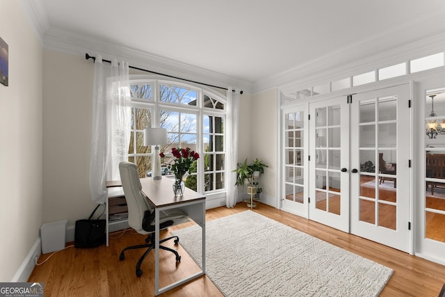 office space featuring french doors, wood finished floors, baseboards, and ornamental molding