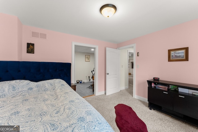 bedroom featuring visible vents, baseboards, and light colored carpet