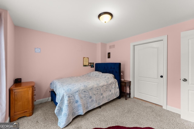 carpeted bedroom with visible vents and baseboards