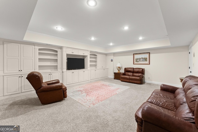 carpeted living area with recessed lighting, baseboards, a raised ceiling, and built in features