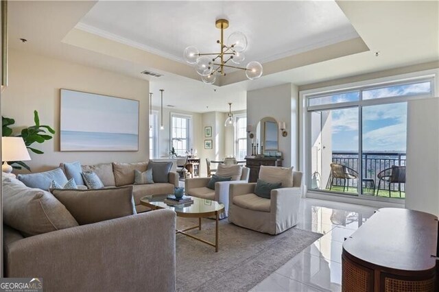 living area featuring a chandelier, visible vents, crown molding, and a tray ceiling