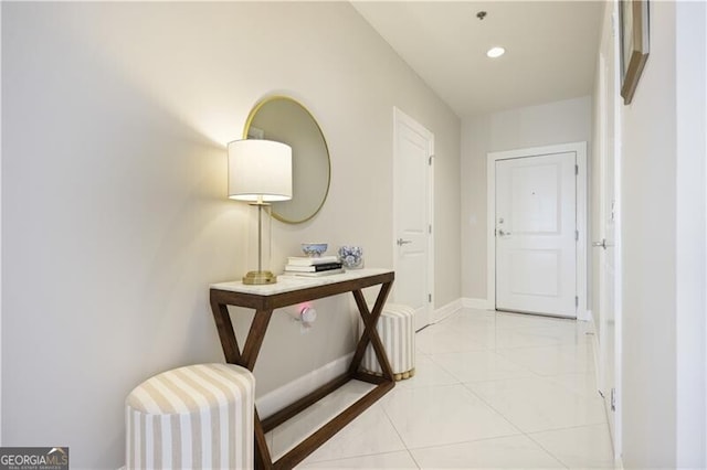 hall with light tile patterned flooring, recessed lighting, and baseboards