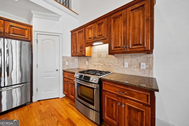 1372 Buckingham Ct, Watkinsville, GA 30677 - kitchen featuring backsplash, appliances with stainless steel finishes, light wood-style floors, and dark stone counters