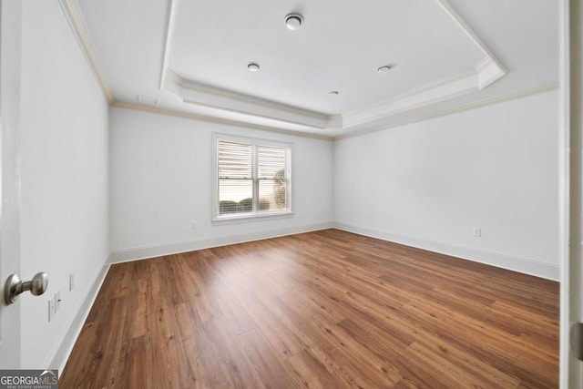 1372 Buckingham Ct, Watkinsville, GA 30677 - empty room with a tray ceiling, baseboards, crown molding, and wood finished floors