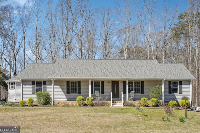 ranch-style home featuring a front yard, a porch, and roof with shingles