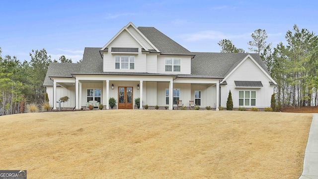 view of front of house with french doors, a porch, board and batten siding, and roof with shingles